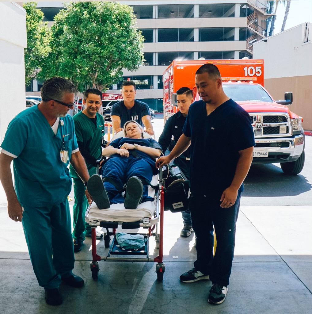 Emergency department staff pulling patient on a gurney into the ED SO 2023 Celebration of Hope awardees